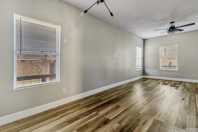 spare room featuring hardwood / wood-style floors and ceiling fan