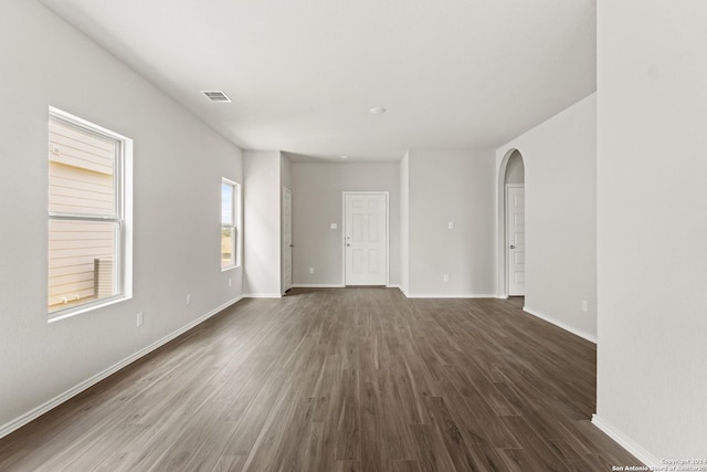 spare room featuring dark wood-type flooring