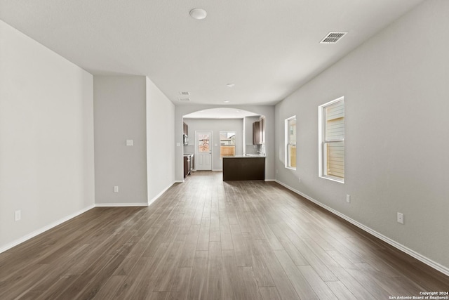 unfurnished living room featuring dark hardwood / wood-style floors