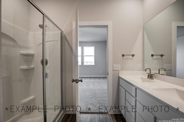 bathroom featuring vanity, hardwood / wood-style floors, and a shower with shower door