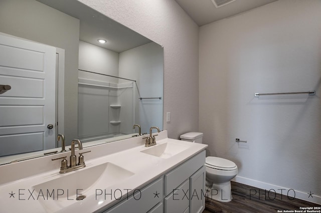 bathroom with wood-type flooring, vanity, and toilet