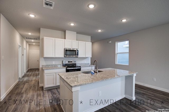 kitchen with white cabinets, a kitchen island with sink, stainless steel appliances, and sink