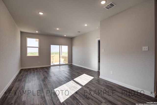 spare room with dark hardwood / wood-style flooring