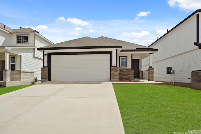 view of front of home with a porch, a front yard, and a garage