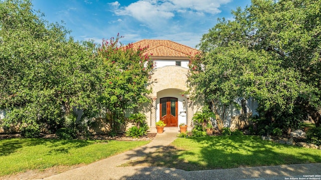 mediterranean / spanish-style home with a front lawn