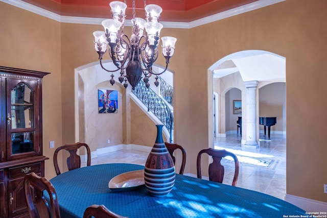 dining room with an inviting chandelier, crown molding, and a high ceiling