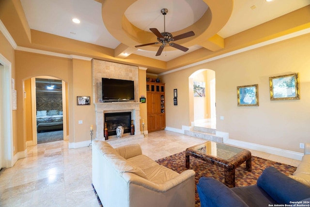 living room with crown molding, a large fireplace, and ceiling fan