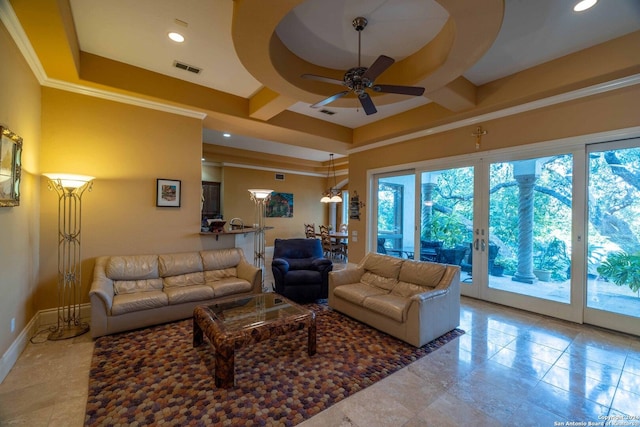 living room featuring ornamental molding, a raised ceiling, and ceiling fan