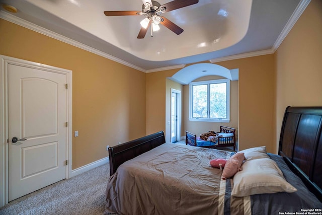 bedroom featuring a raised ceiling, crown molding, and light colored carpet