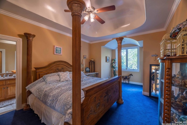 bedroom with carpet flooring, ornamental molding, a tray ceiling, and ornate columns