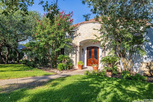 mediterranean / spanish-style house featuring a front lawn