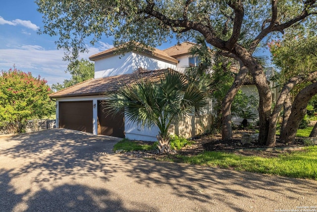 view of side of home featuring a garage