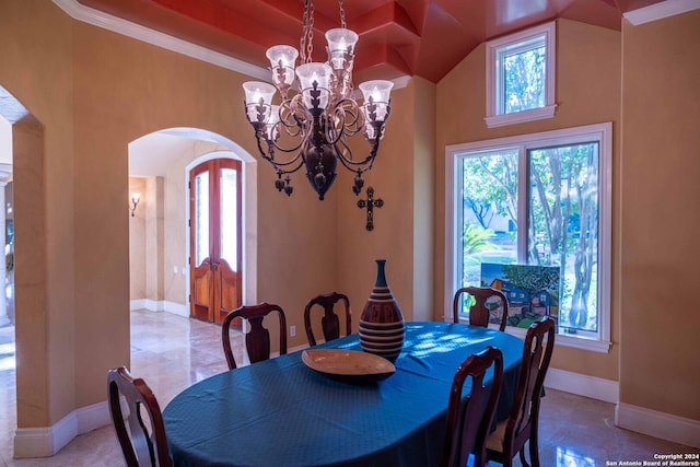 dining area with an inviting chandelier and ornamental molding