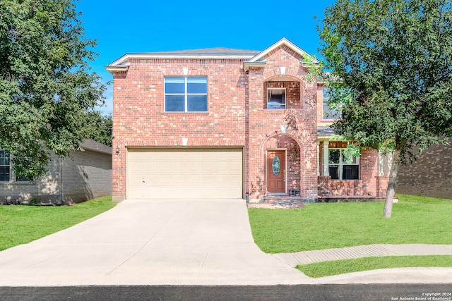 view of front of property with a garage and a front lawn