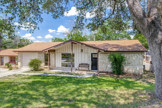 ranch-style home with a garage and a front yard