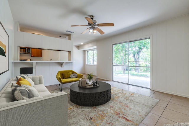 living room featuring ceiling fan and light tile patterned floors