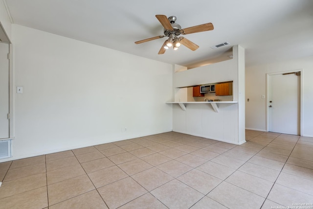 unfurnished living room featuring light tile patterned floors and ceiling fan