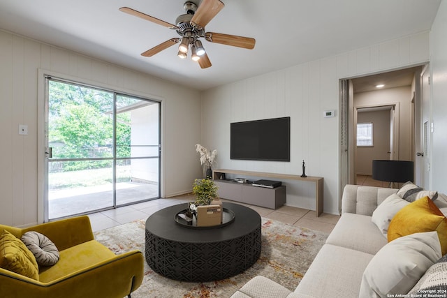 living room with ceiling fan and light tile patterned flooring