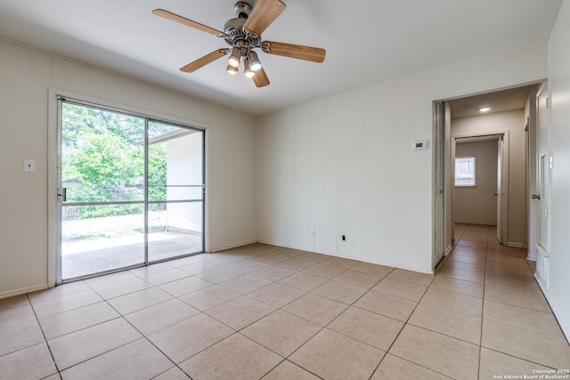 spare room with ceiling fan and light tile patterned floors