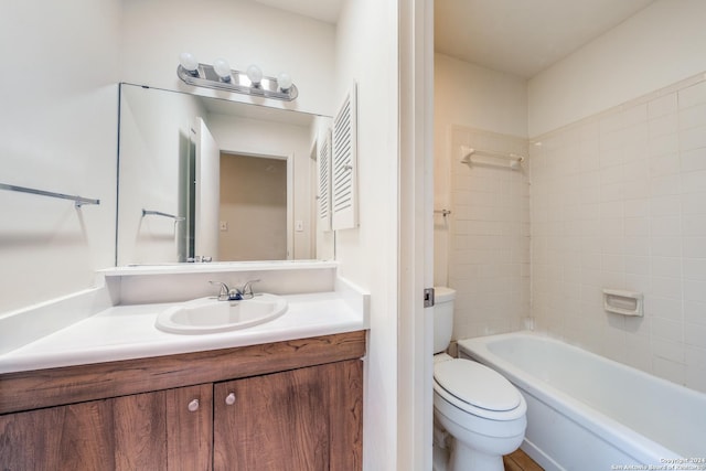 full bathroom with tiled shower / bath combo, vanity, and toilet