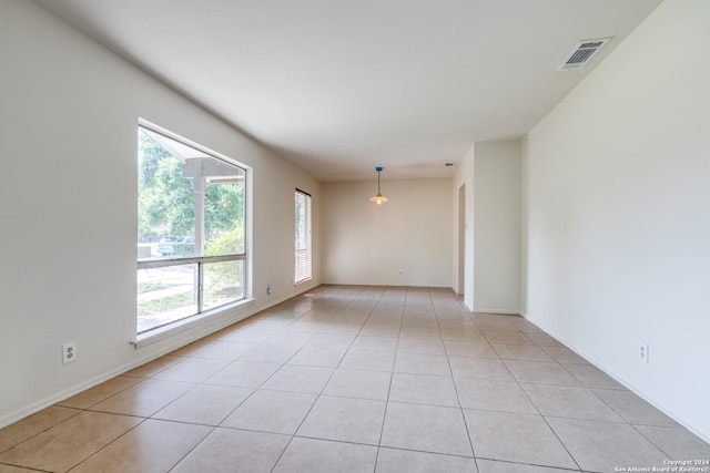 unfurnished room featuring light tile patterned flooring