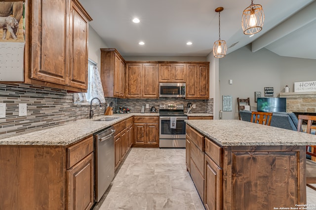 kitchen with tasteful backsplash, stainless steel appliances, pendant lighting, sink, and light tile patterned floors