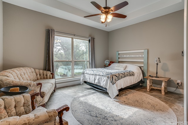 tiled bedroom with ceiling fan and baseboard heating