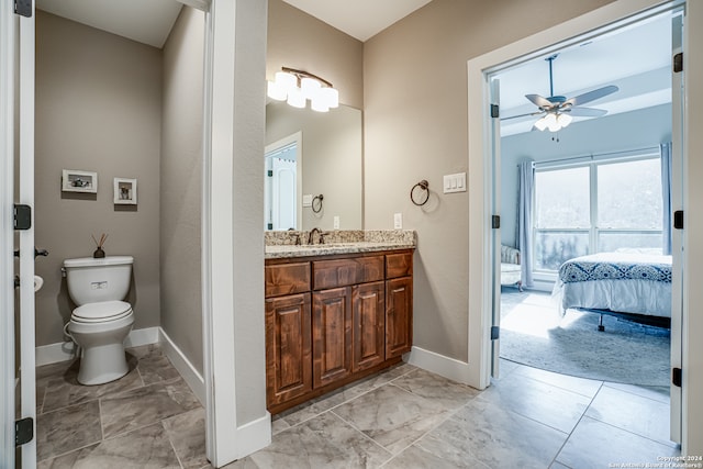 bathroom featuring vanity, tile patterned flooring, ceiling fan, and toilet