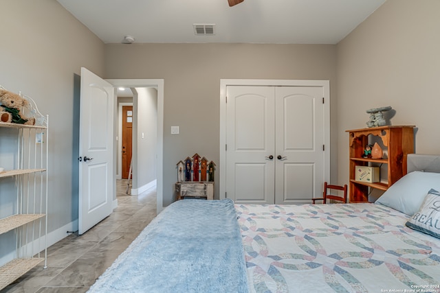 bedroom with ceiling fan, a closet, and light tile patterned floors