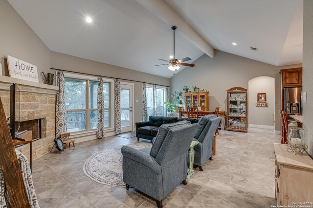 tiled living room with high vaulted ceiling and ceiling fan