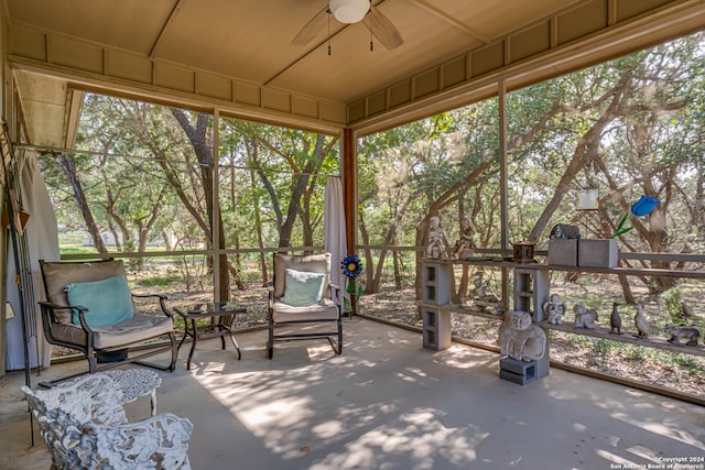 unfurnished sunroom with ceiling fan