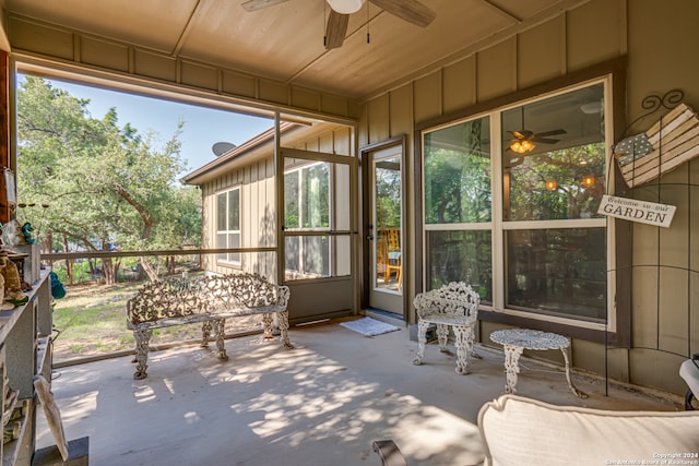 unfurnished sunroom with ceiling fan