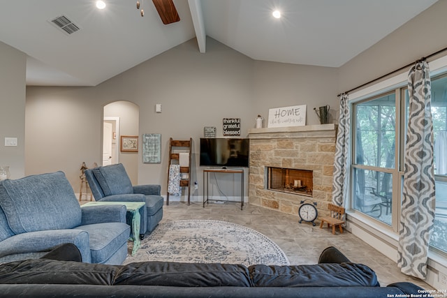 living room featuring vaulted ceiling with beams, a fireplace, and light tile patterned floors