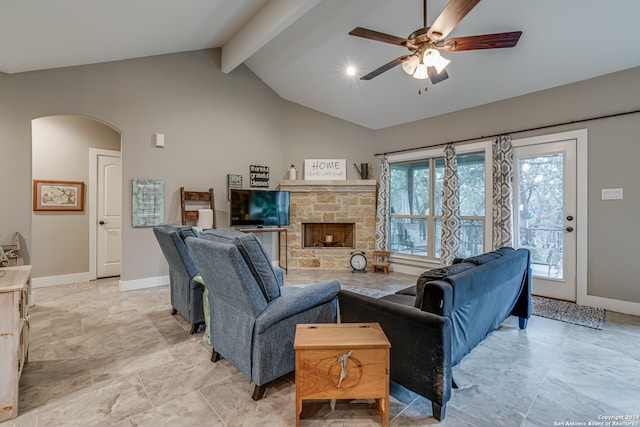 tiled living room with a fireplace, ceiling fan, and vaulted ceiling with beams