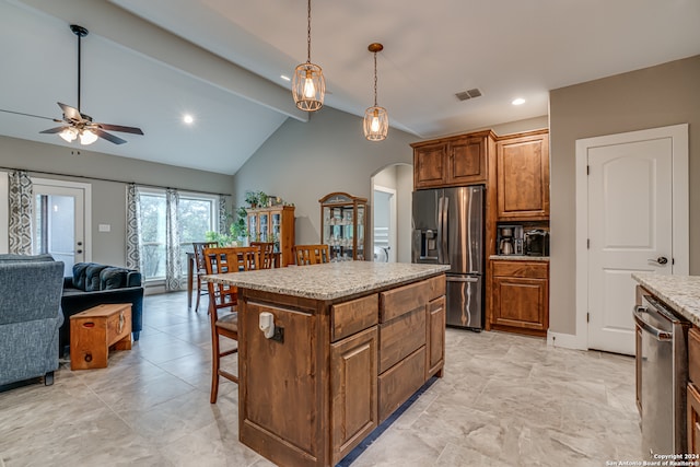 kitchen with light tile patterned flooring, lofted ceiling, a center island, ceiling fan, and appliances with stainless steel finishes