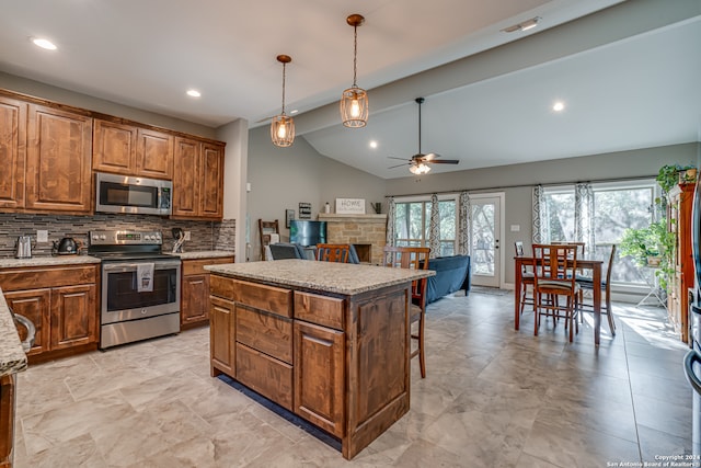 kitchen featuring appliances with stainless steel finishes, ceiling fan, a wealth of natural light, and light tile patterned floors