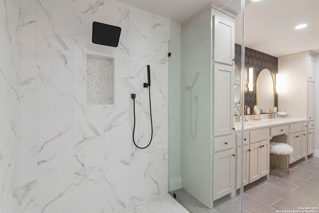 bathroom featuring a shower with shower door, vanity, and tile patterned floors