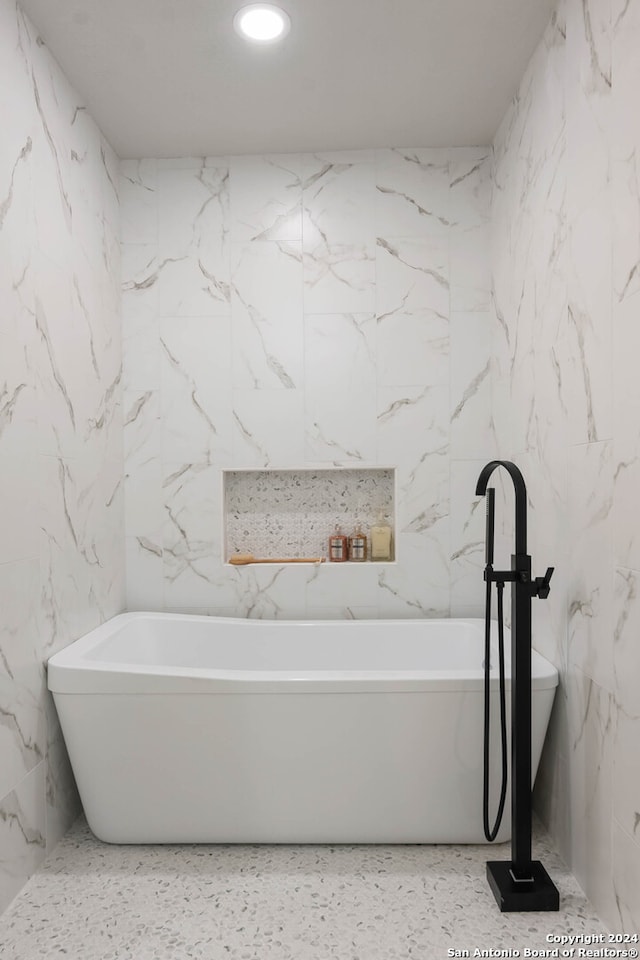 bathroom with tile walls