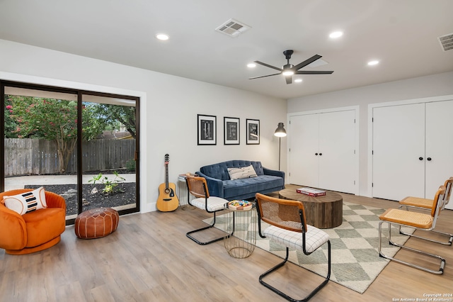 living room featuring light wood-type flooring and ceiling fan