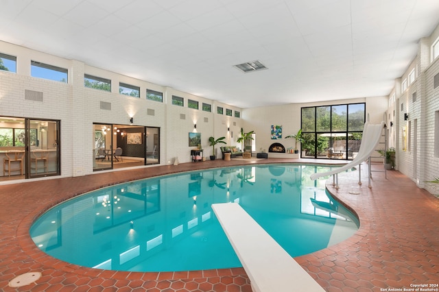 view of swimming pool with a diving board and a water slide