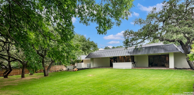 back of house with a lawn