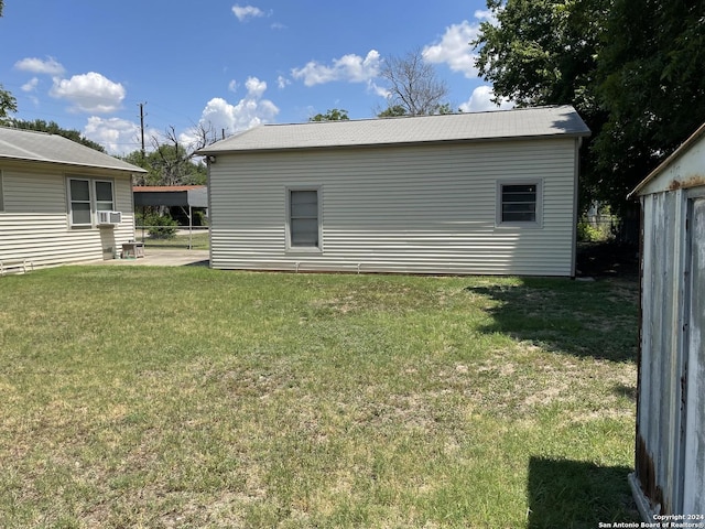 exterior space with cooling unit and a yard