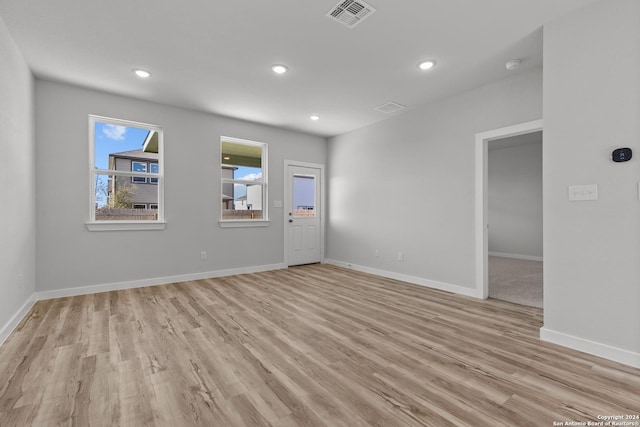 spare room with light hardwood / wood-style flooring