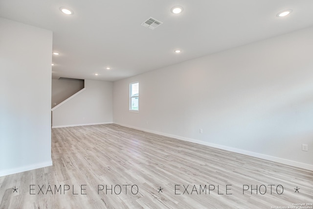 unfurnished room with light wood-type flooring