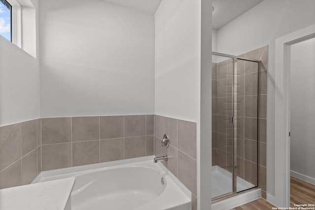 2540 Solon Ln, Seguin, TX 78155 - bathroom featuring a shower stall, wood finished floors, and a bath