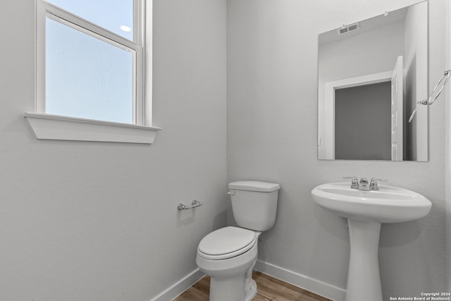 2540 Solon Ln, Seguin, TX 78155 - half bath featuring baseboards, visible vents, toilet, and wood finished floors