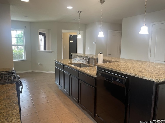 kitchen featuring pendant lighting, black dishwasher, an island with sink, and sink