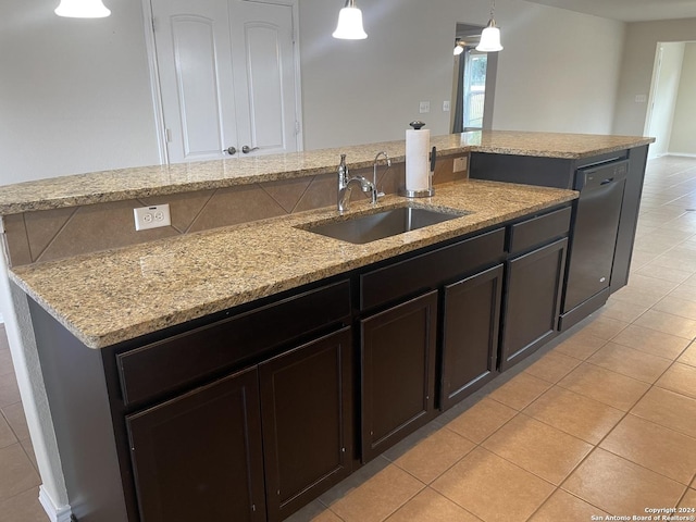 kitchen featuring dishwasher, sink, pendant lighting, and light stone counters