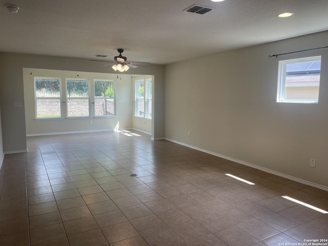 unfurnished room featuring ceiling fan and light tile patterned floors