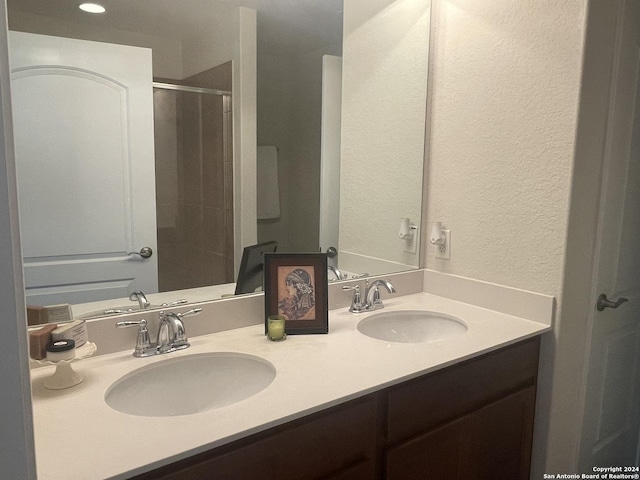 bathroom with vanity and a shower with shower door